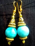 Bluegreen glass bead with golden beads and findings