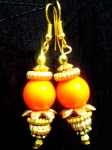 Orange glass bead with wooden flower, golden beads and findings