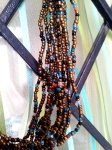Gold, brown, blue and red beaded multi-strand necklace